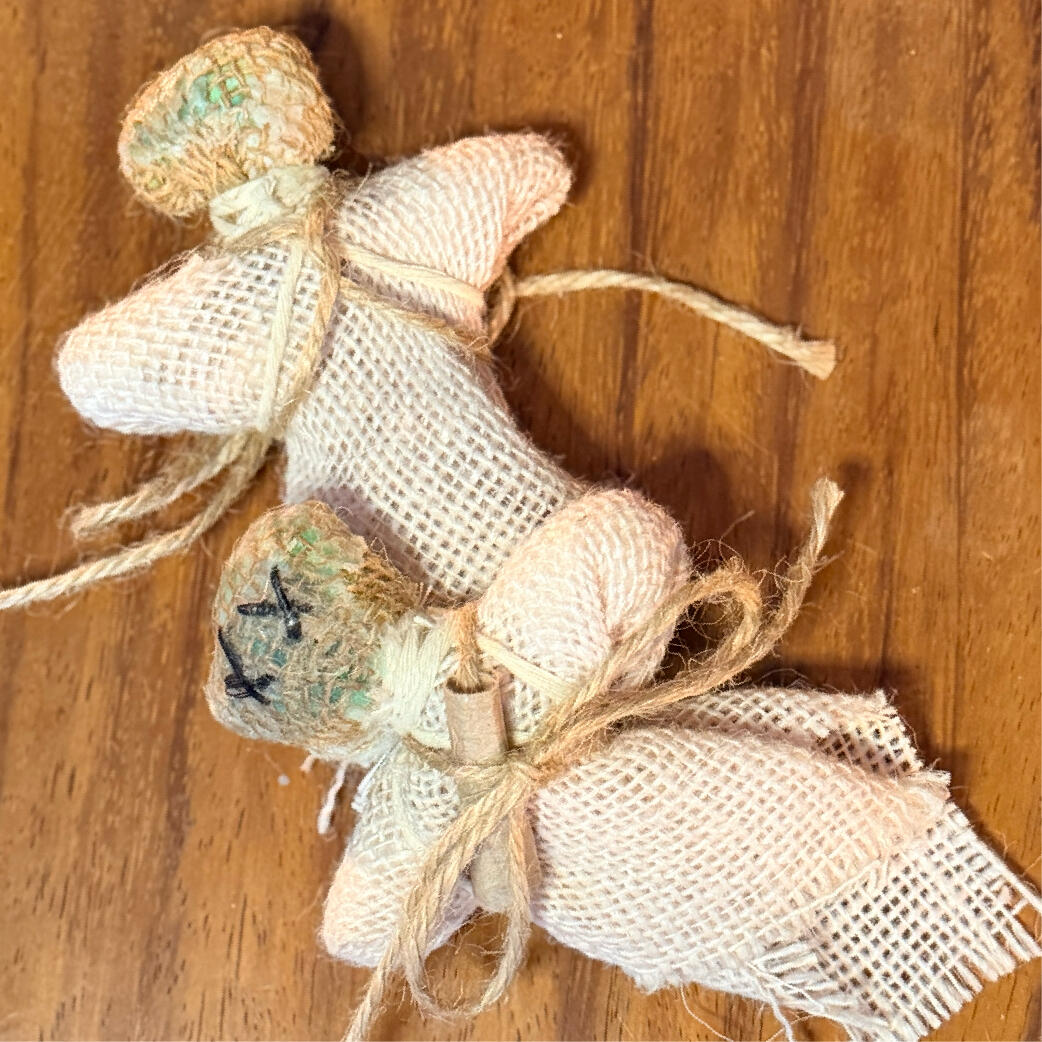 Two handmade Cinderwitch burning poppets, front and back, with X-stitched faces and burlap bodies, by WMFrewolfe