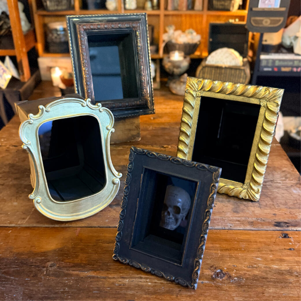 Scrywell - No two alike Group of handmade black scrying mirrors in varied frames, a face caught in the dark of one, Scrywells by WMFrewolfe