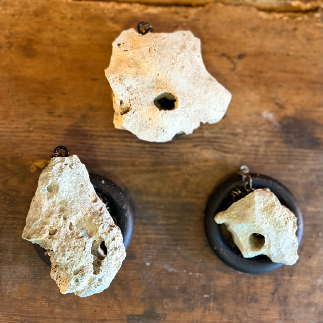 Three natural hagstones with holes worn by water, paired with dark rings, Hagulum by WMFrewolfe