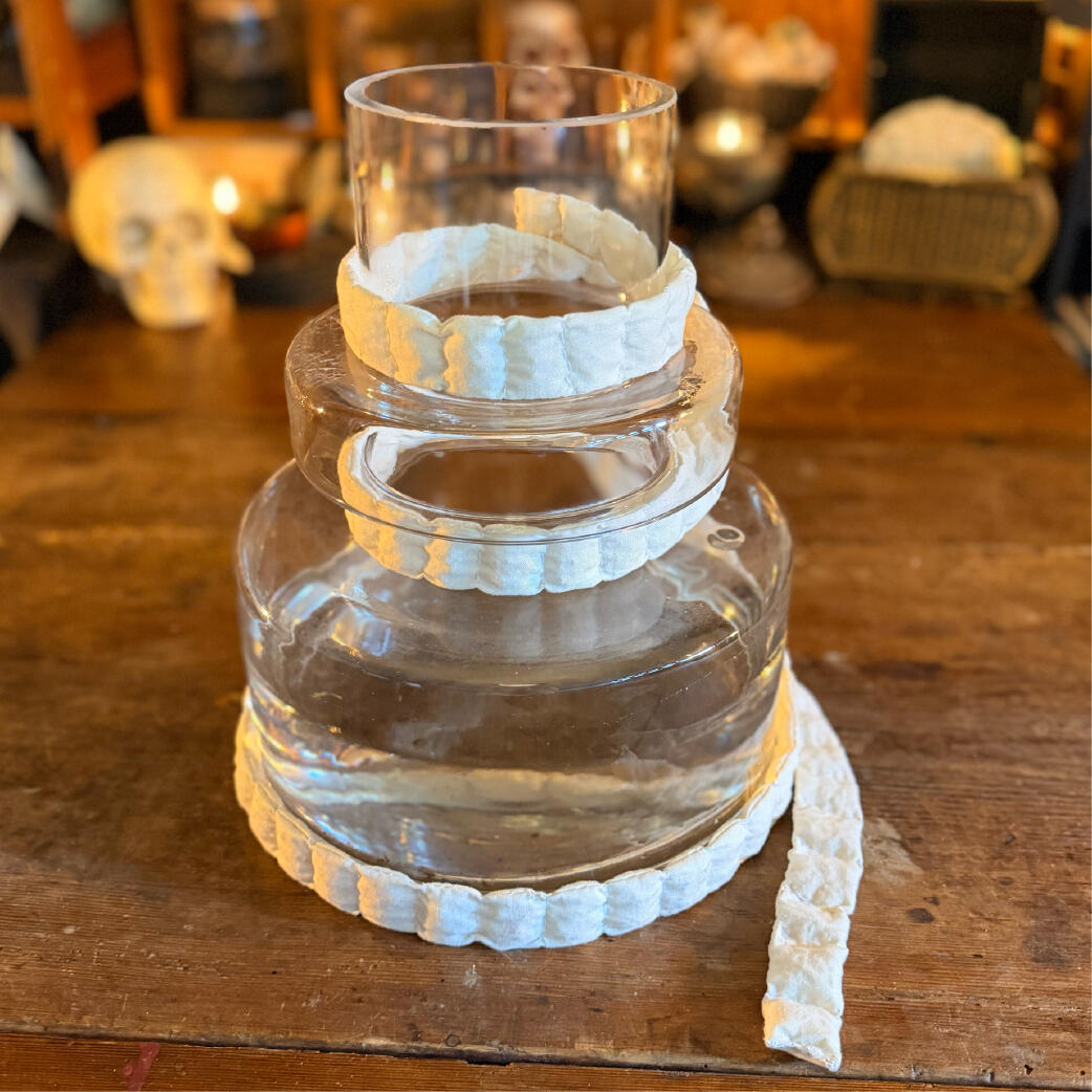 Saltcord wound around a glass vessel of storm water, handmade salt ward by WMFrewolfe